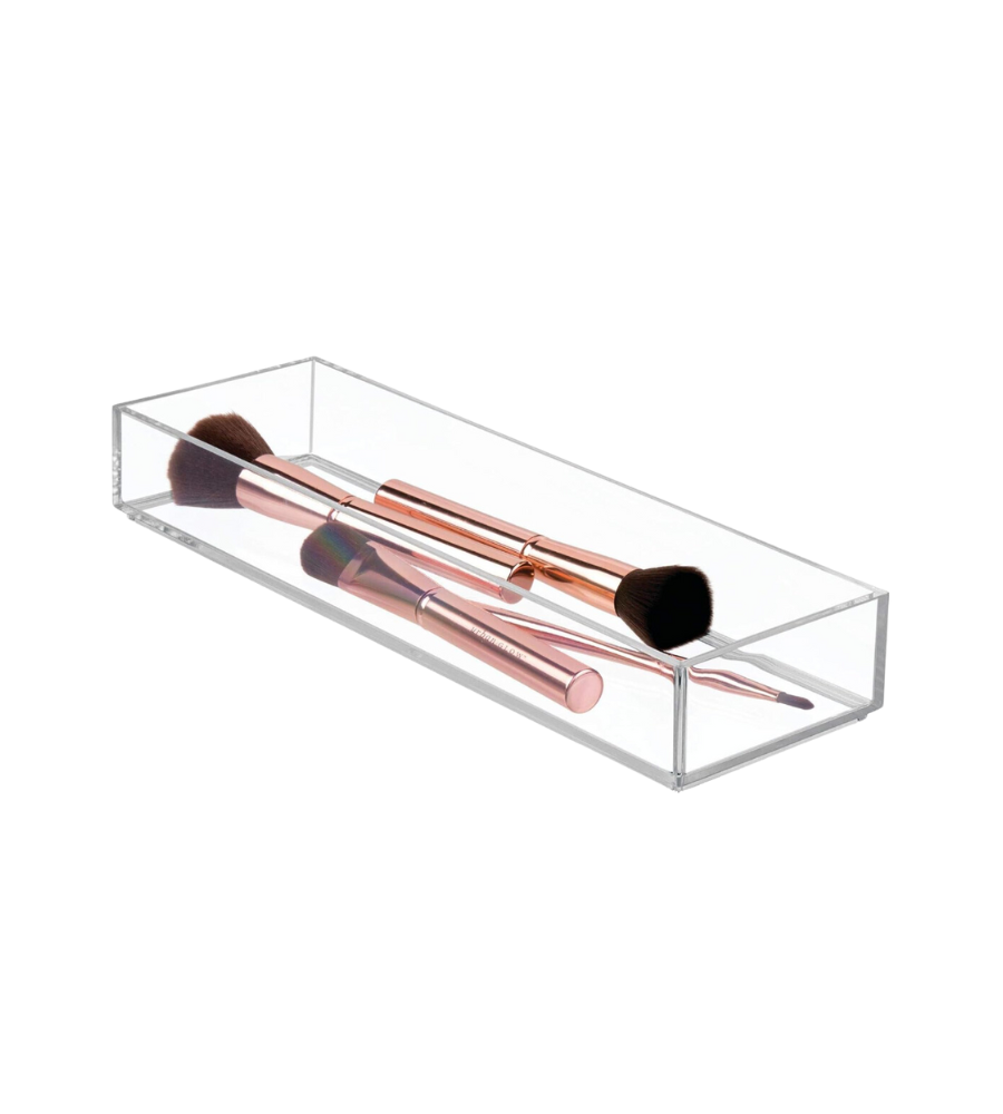 Transparente Box mit vier Make-up-Pinseln, roségoldene Griffe.